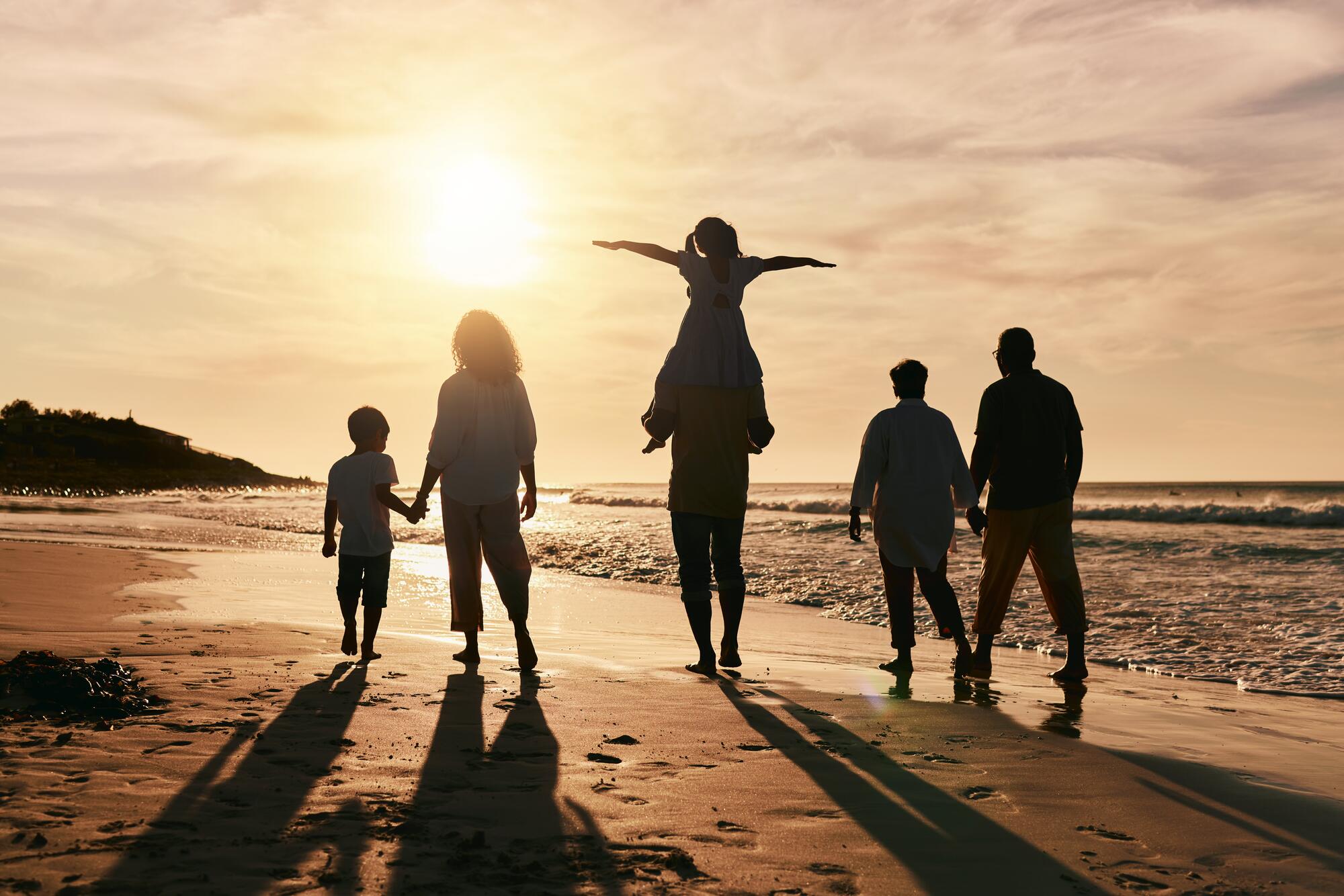 family at the beach looking joyful